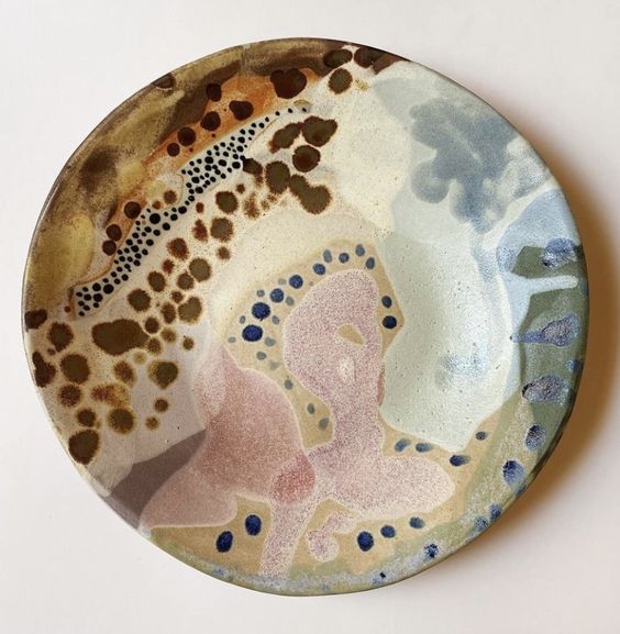 Glazed ceramic plate with splotched pattern.