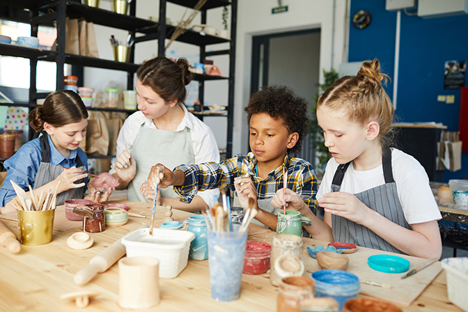 Kids at a paint pottery lesson.